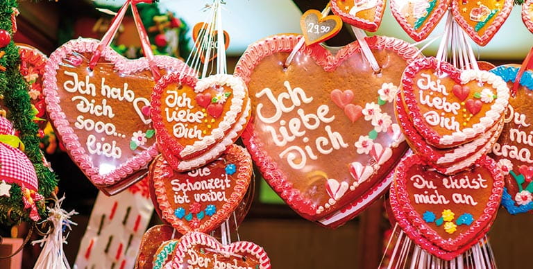 Festive gingerbread cookies icing with phrases in German
